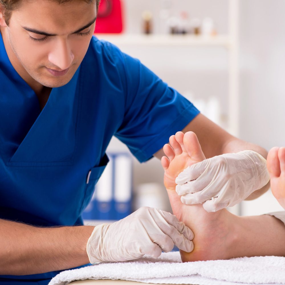 Podiatrist treating feet during procedure