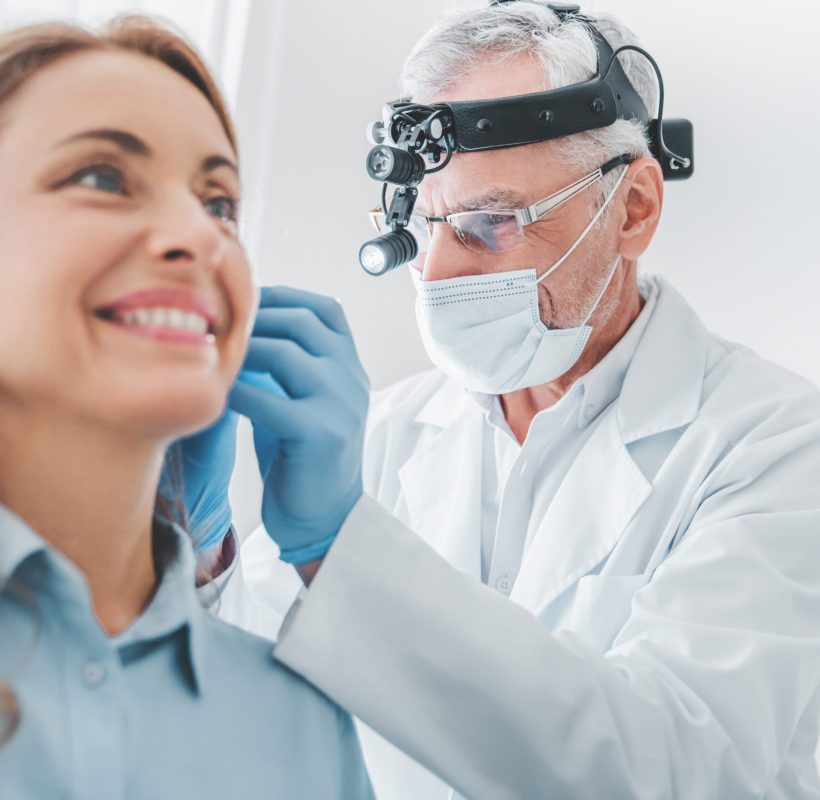 Close up of adult caucasian female patient visiting doctor otolaryngologist