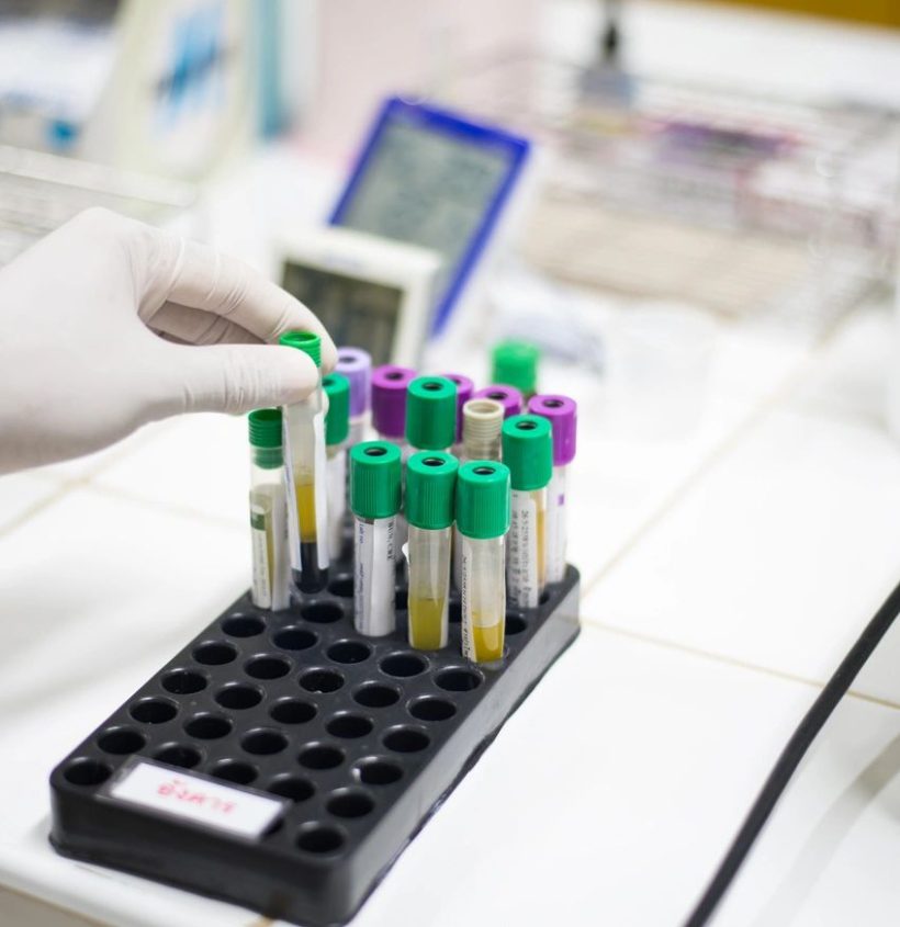 technicians operating machine in laboratory.